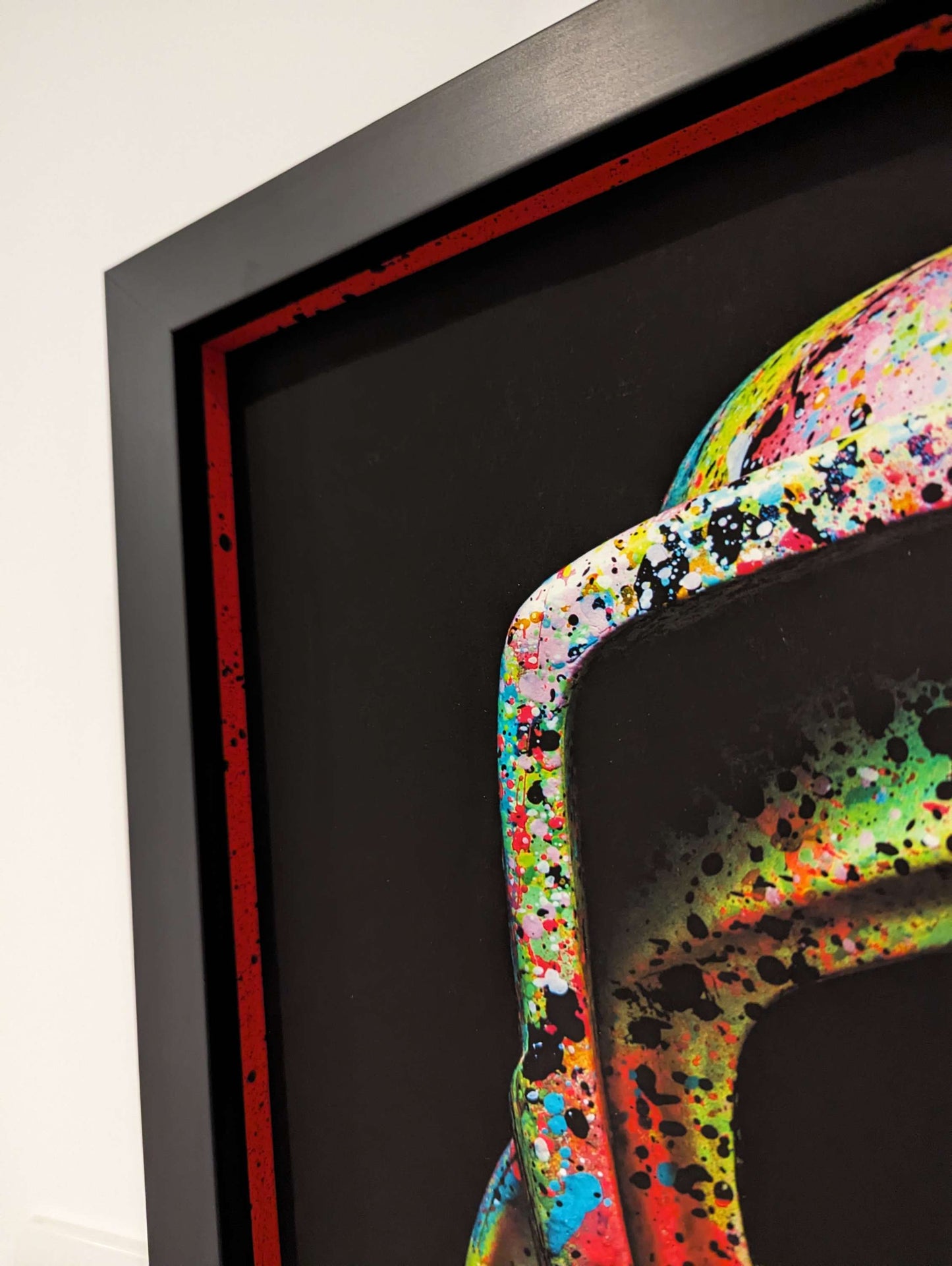 Framed artwork with a colorful abstract design on a black background