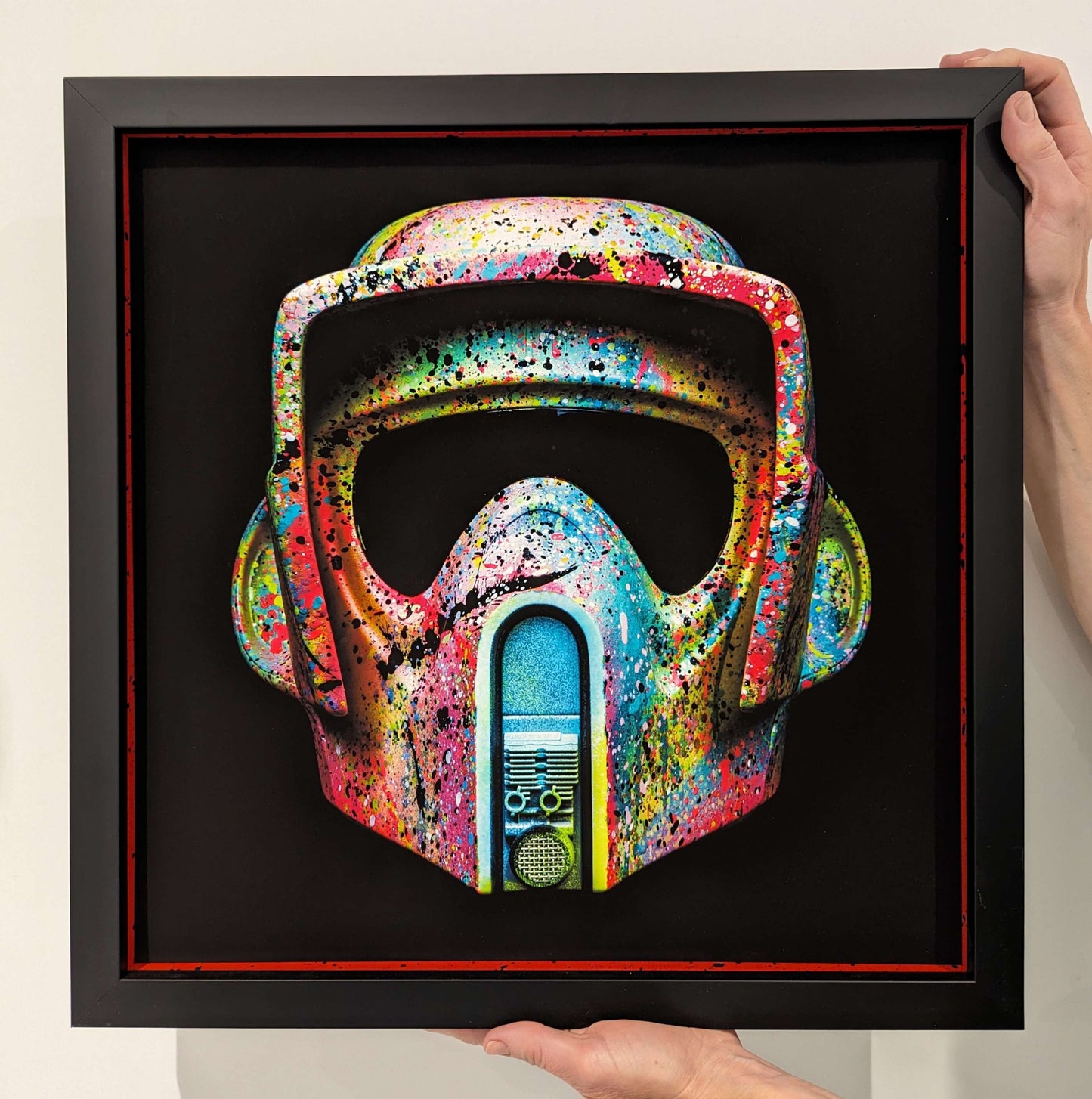 LP edits starwars mask with graffiti style finish in black frame being held in corners in front of white background