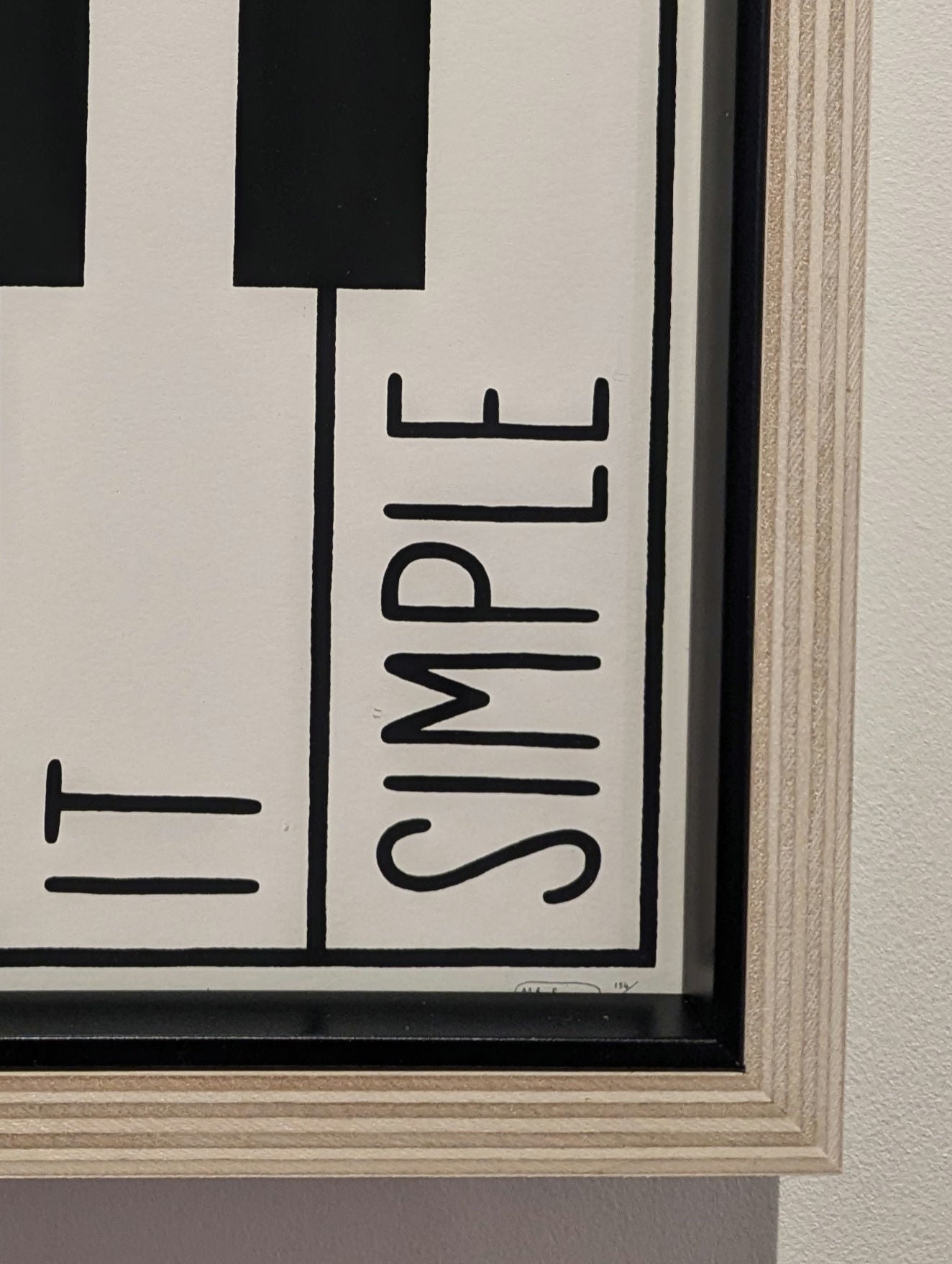 mr bingo keep it simple text on piano style black and white print, framed in plywood frame with black slip