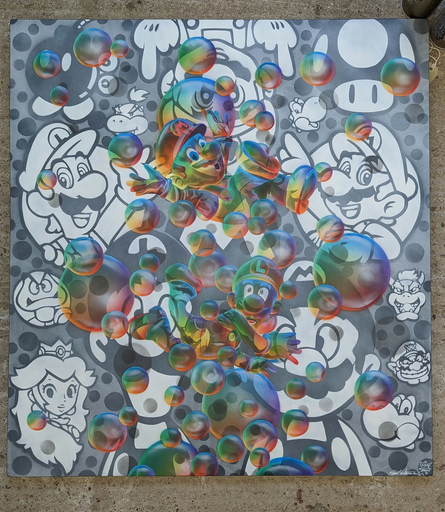 A piece of pop art featuring colorful bubble-like structures and characters reminiscent of a super mario video game, set against a concrete background.