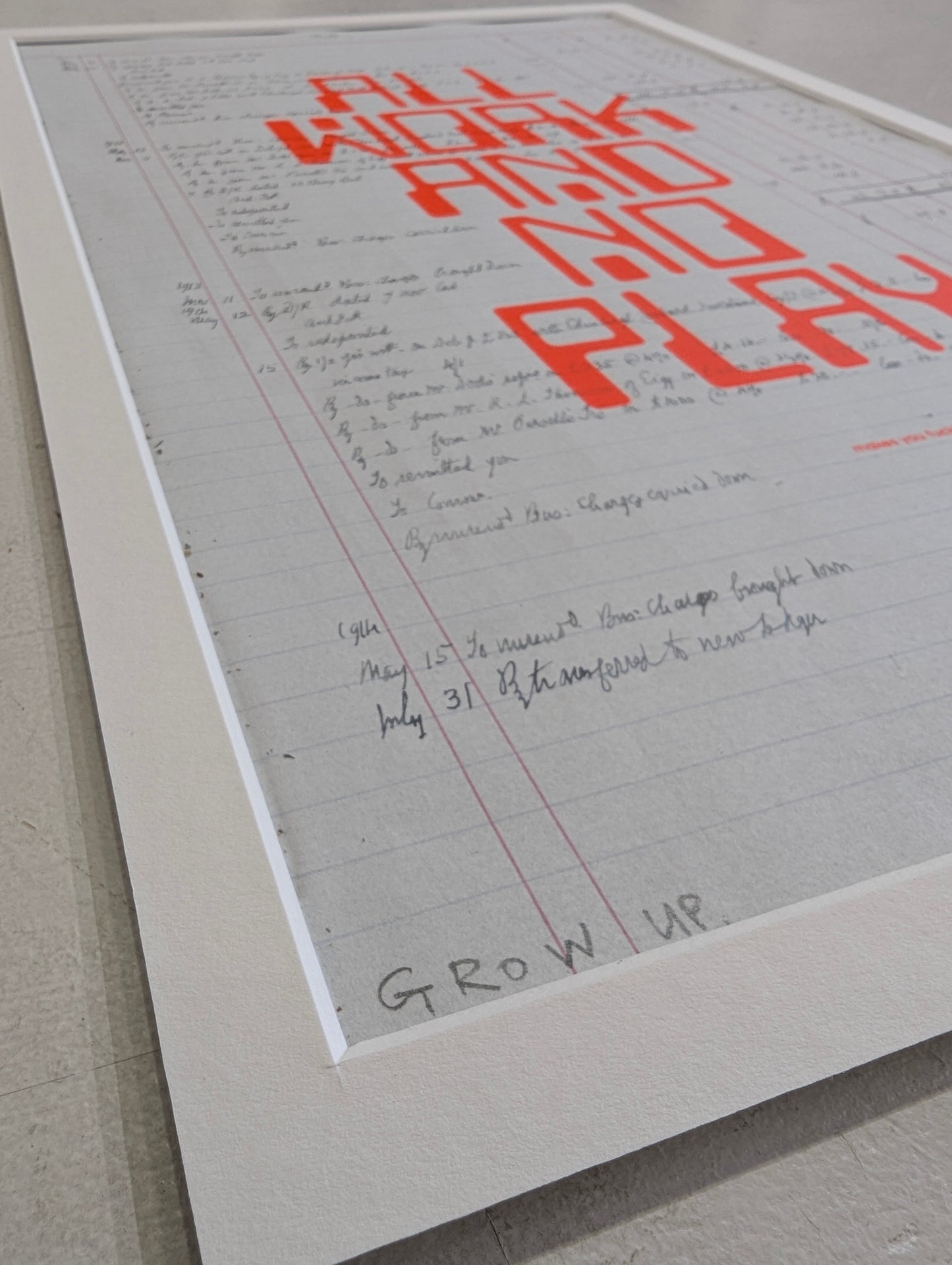 Printed text with 'All Work and No Play' in red on a light gray background, corner shot with mount