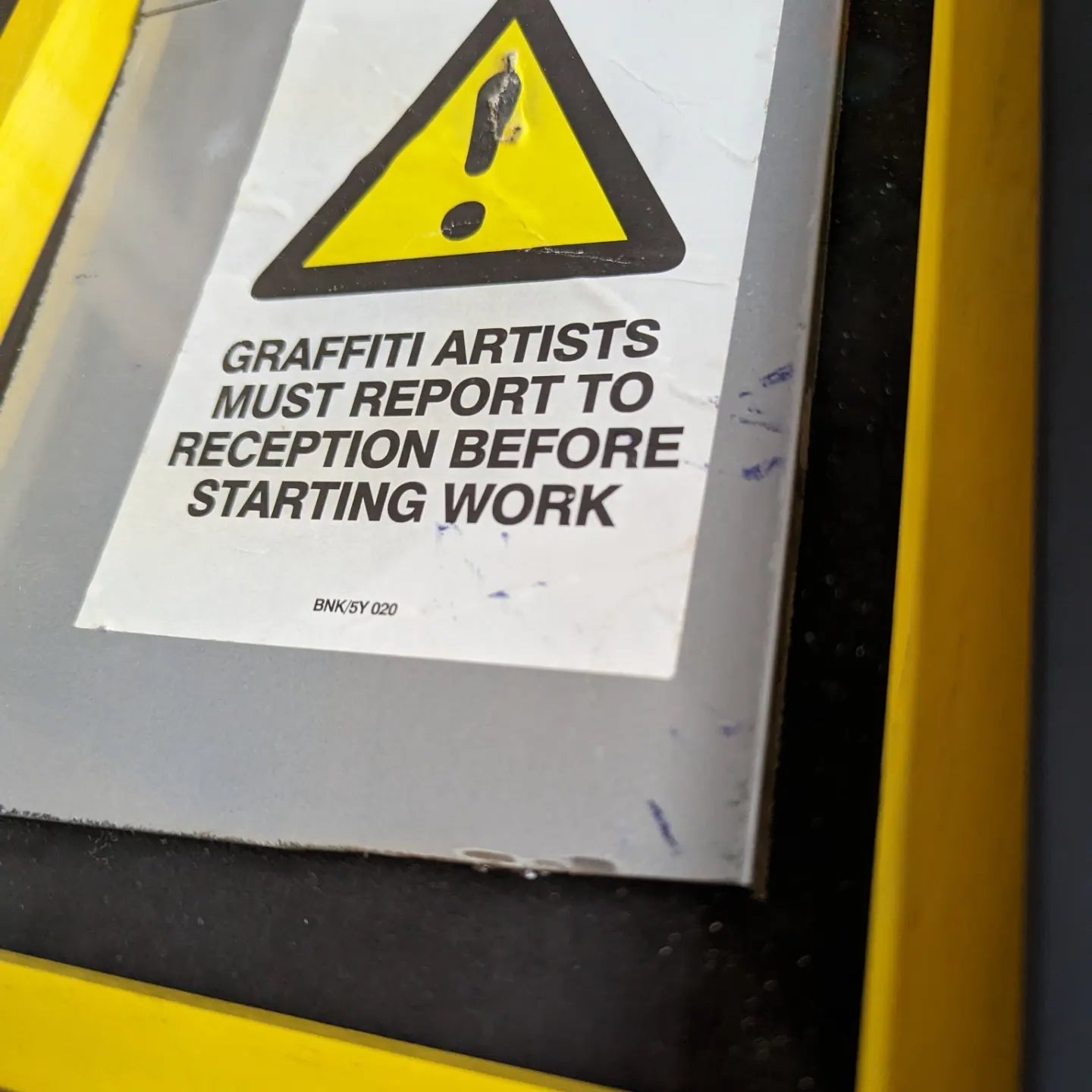 Banksy - Graffiti Artists Must Report To Reception Before Starting Work close up interior