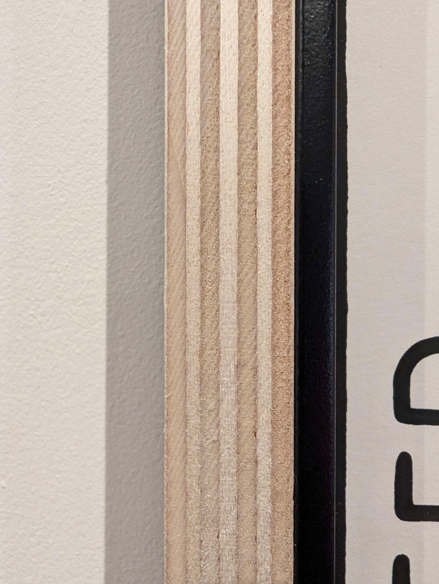 close up of the frame showing grain of the plywood frame with black slip