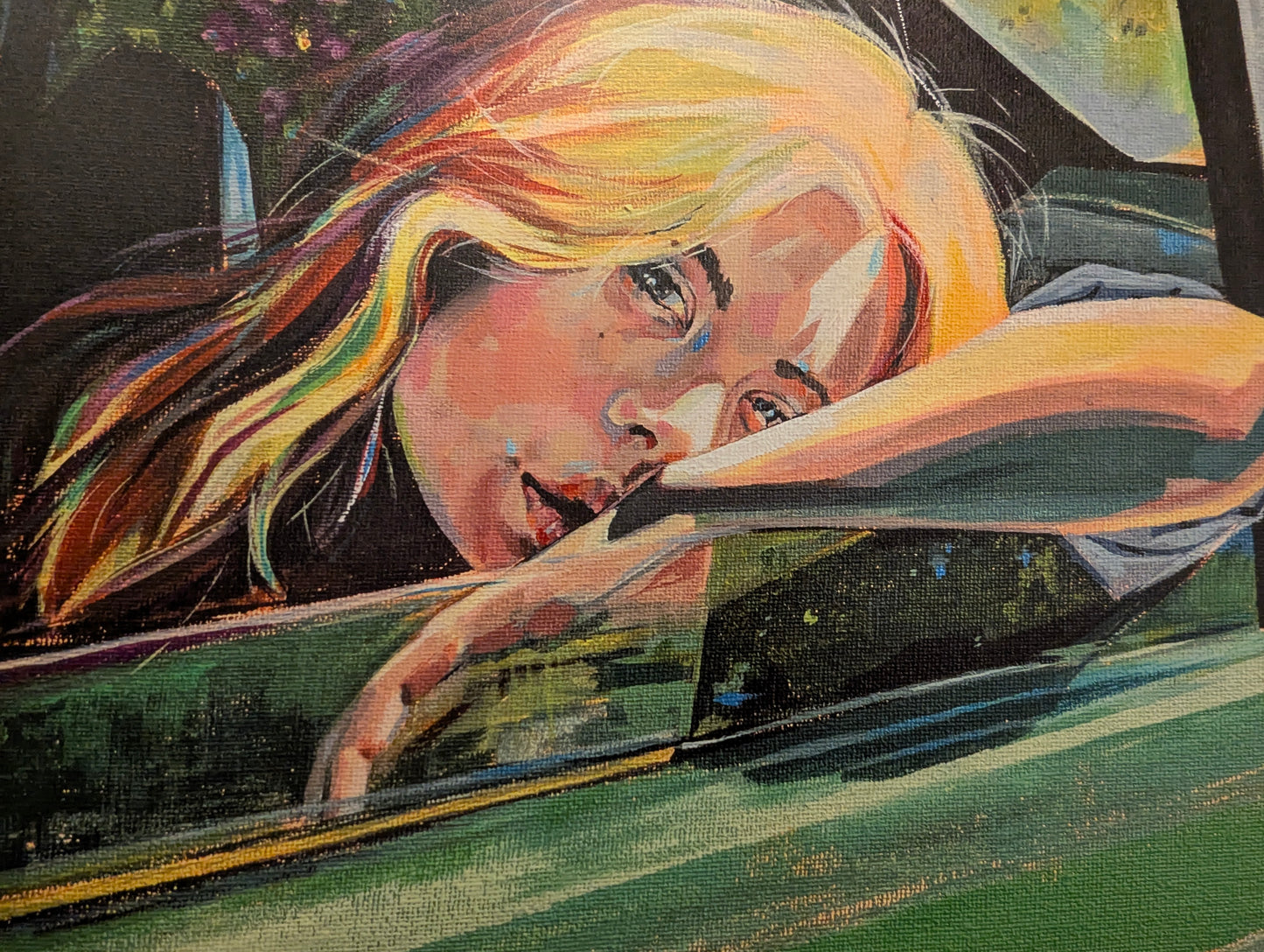 Close-up of a person with colorful hair looking out of a car window.