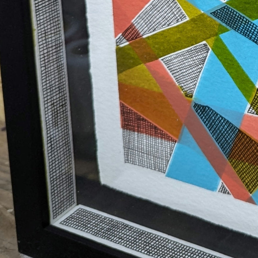 close up of the matching slips in black frame, clare capper artwork is float mounted on black card, artwrok has erratic line and colourful line in orange, green and blue.