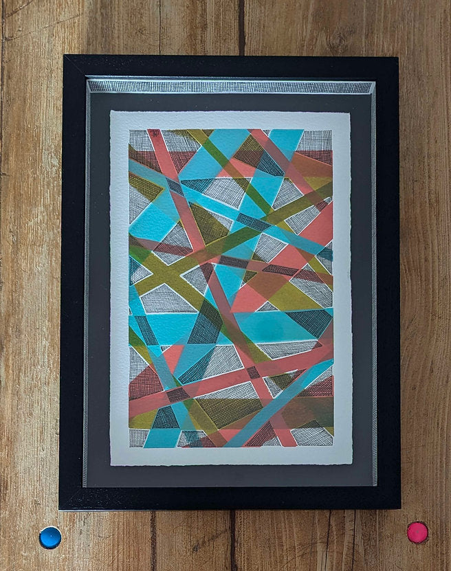 black frame against wood background, clare capper artwork is float mounted on black card, artwrok has erratic line and colourful line in orange, green and blue.