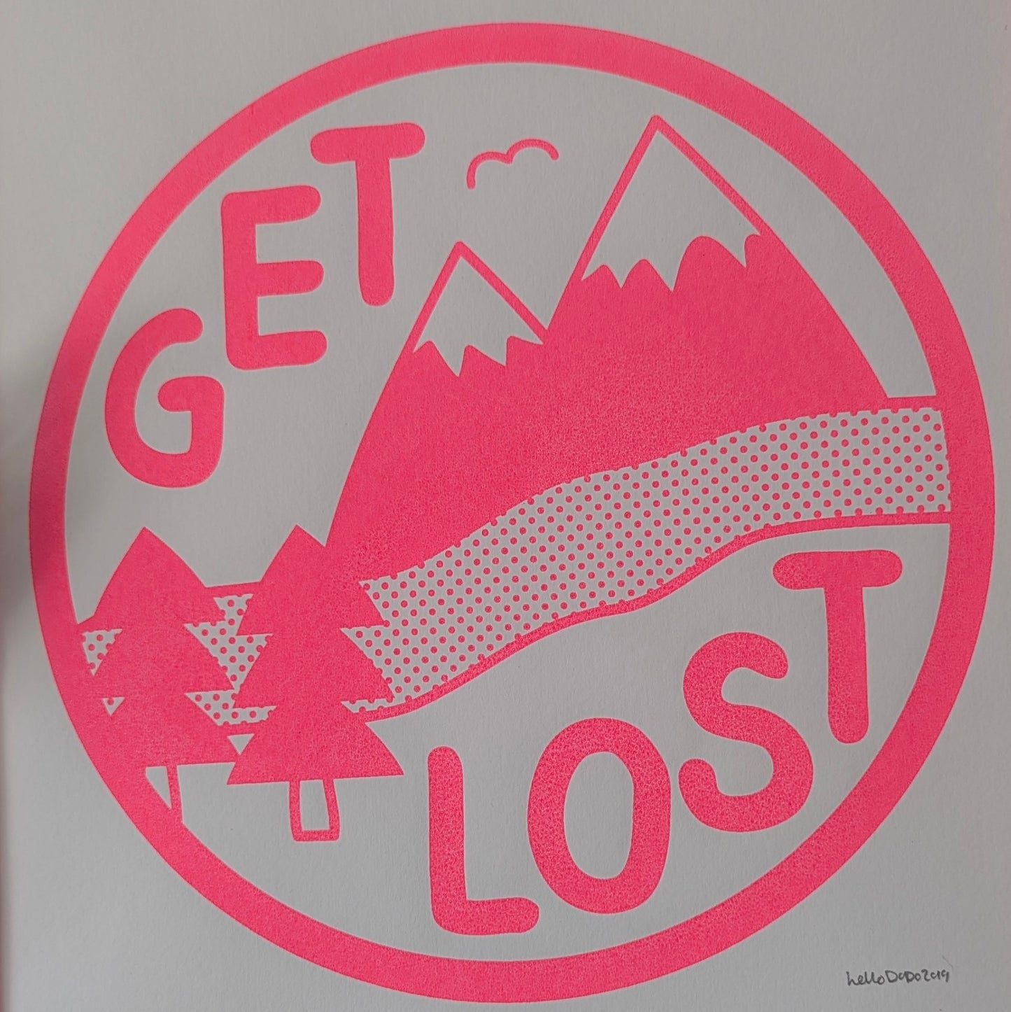 Pink 'GET LOST' graphic with mountain and trees on a gray background
