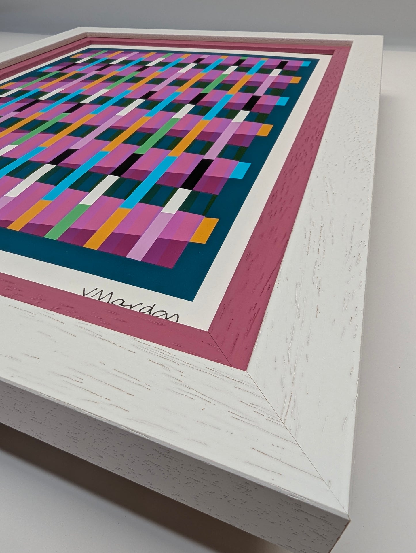 Framed abstract artwork with colorful geometric pattern on a white background