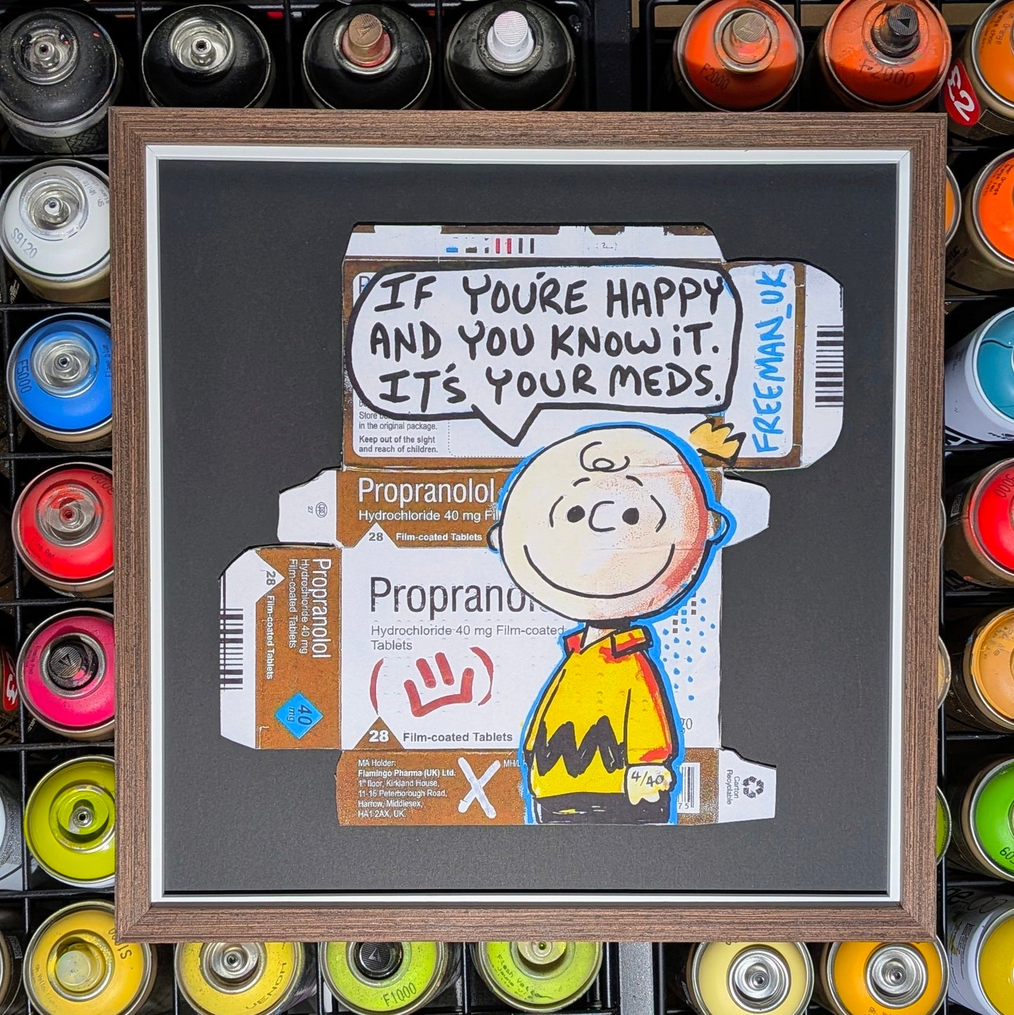 A framed art print featuring a Peanuts-style illustration with a speech bubble reading 'IF YOU'RE HAPPY AND YOU KNOW IT. IT'S YOUR MEDS.