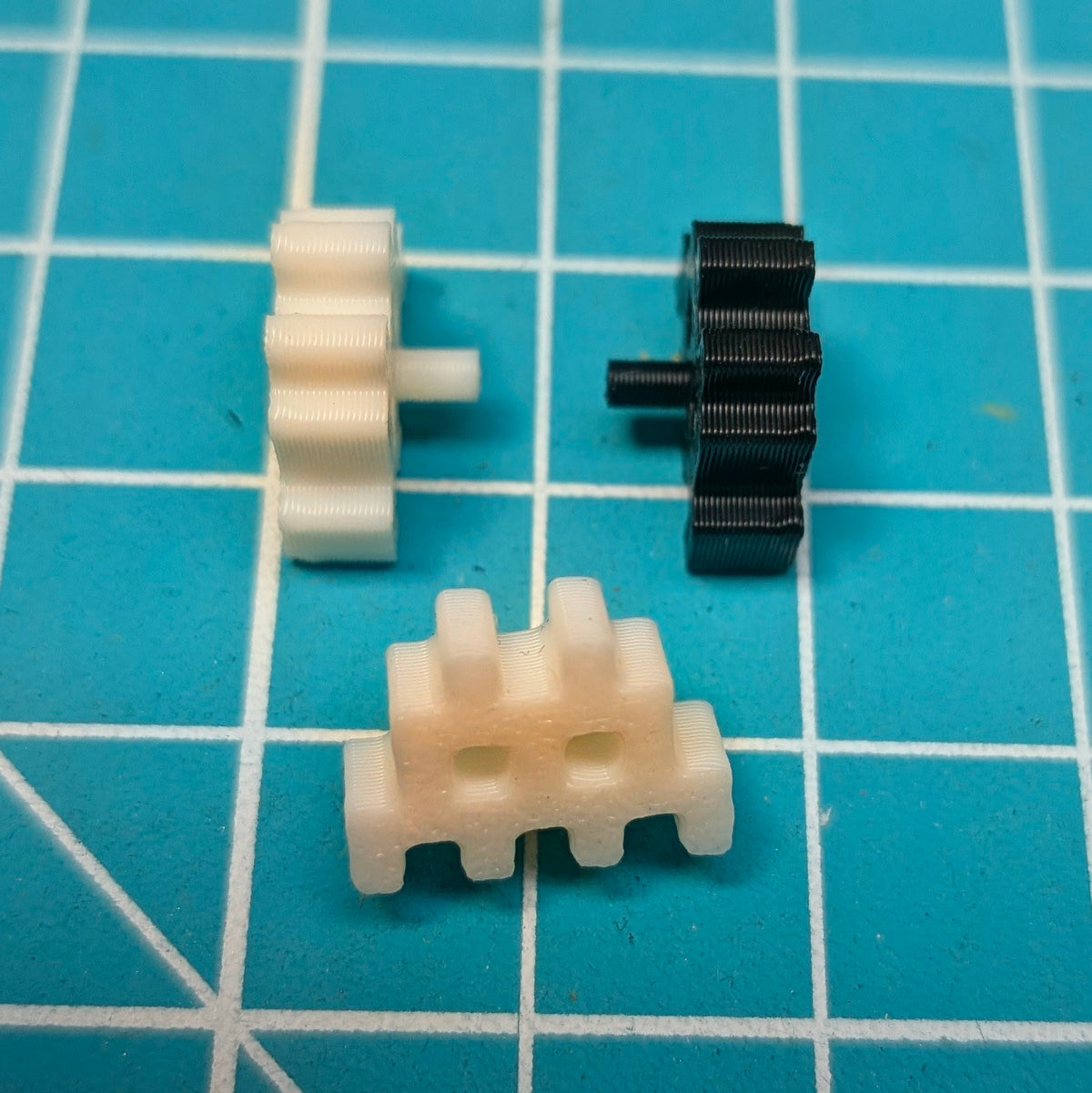 white and black space invader ships against a cutting mat background