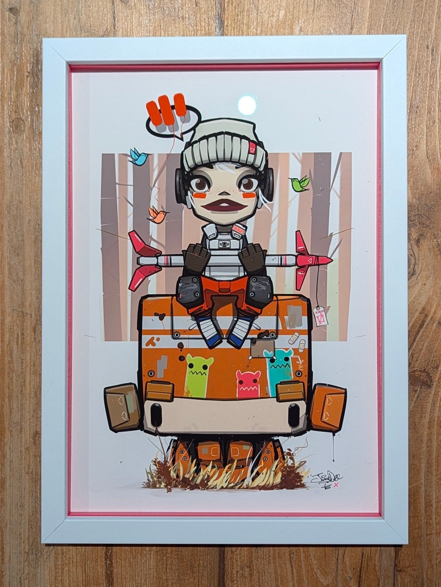anime character sat on an orange robot holding a rocket, the character is wearing a grey wool hat and has red makeup, picture is at an angle showing the colour slips, on a wood table
