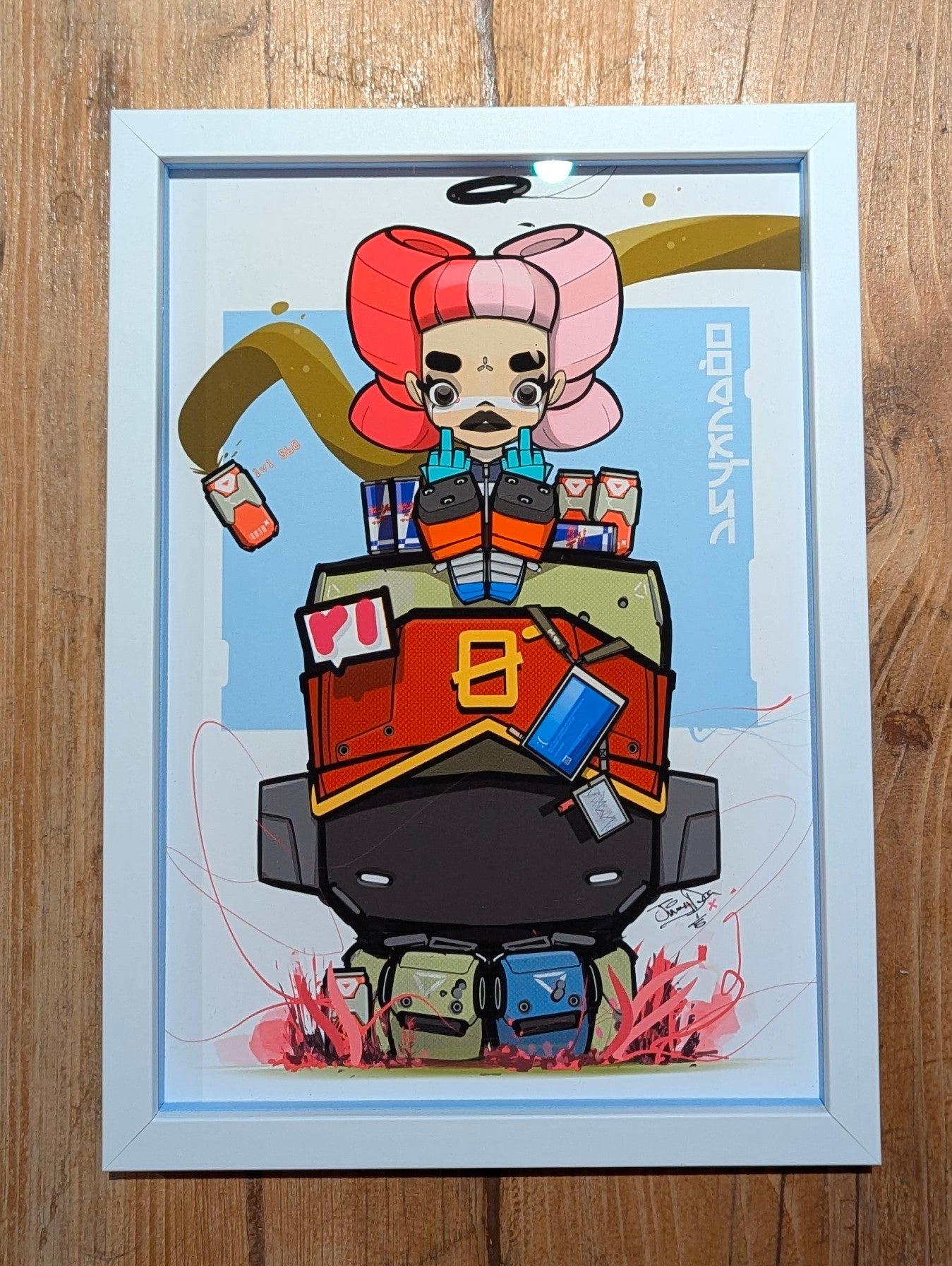 anime character sat on black and red robot, anime character has big red and pink hair, she is also flipping the finger, frame is white with blue slips, frame is on a wooden table