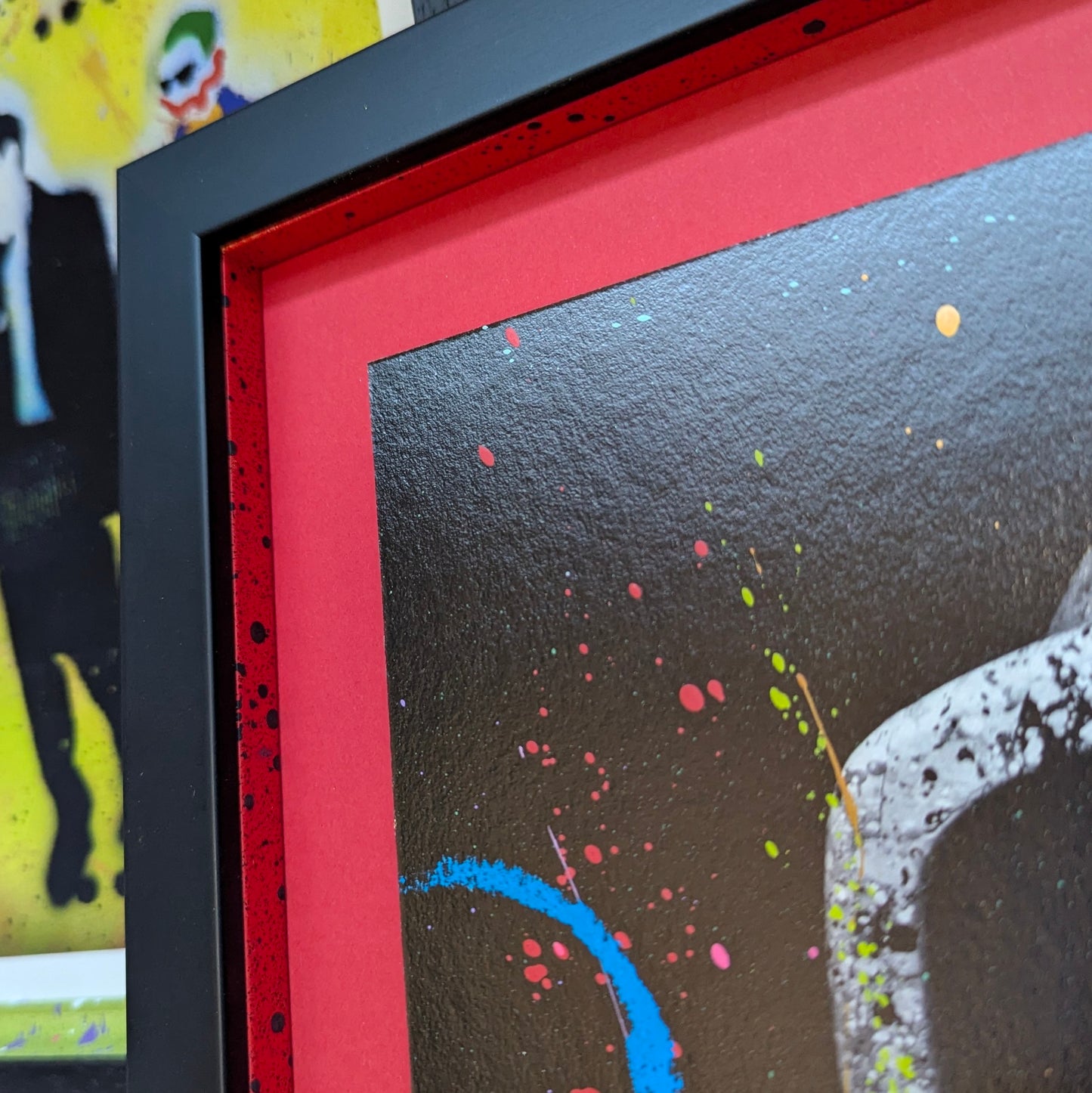 corner of picture frame for LP edits tree hugger, shows close up of the red backing and the matching colour slips with black splatter