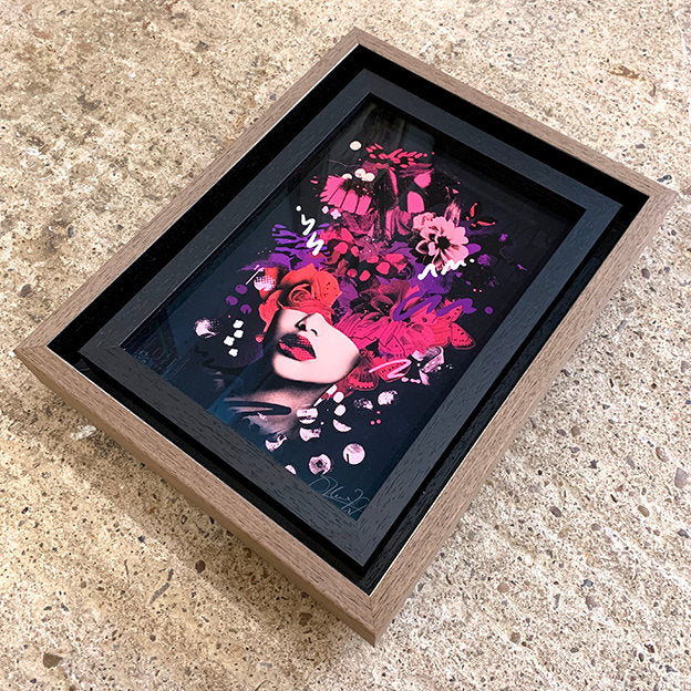 picture frame, double frame, internal frame is black wood grain. outer frame is a brown tray frame style with a black shadow gap. print shows olly howe veil side image. picture is sat on concrete floor.