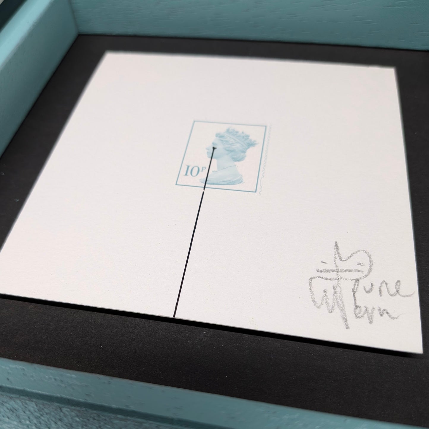 Framed artwork with a signature on a white background