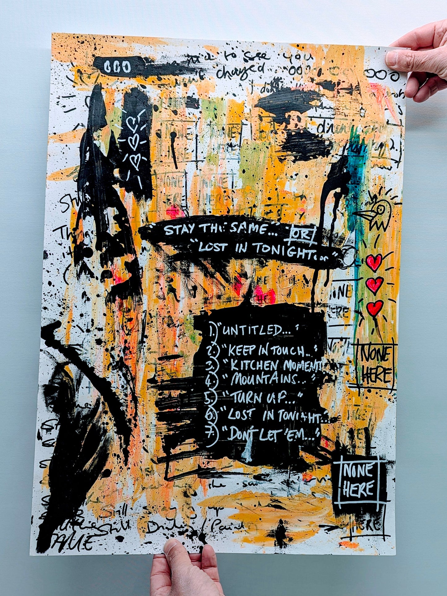 steve mccracken artworkwith his none here signature, artwork has spattered orange with doodles and text added, including a list stating 1. untitled 2. keep in touch 3. kitchen moment 4. mountains 5. turn up 6. lost in tonight 7 don't let em