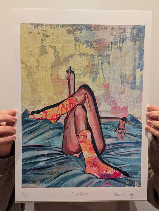 Art print of a colourful abstract scene with a person lying on a bed with colourful socks giving the bird, held by two hands.