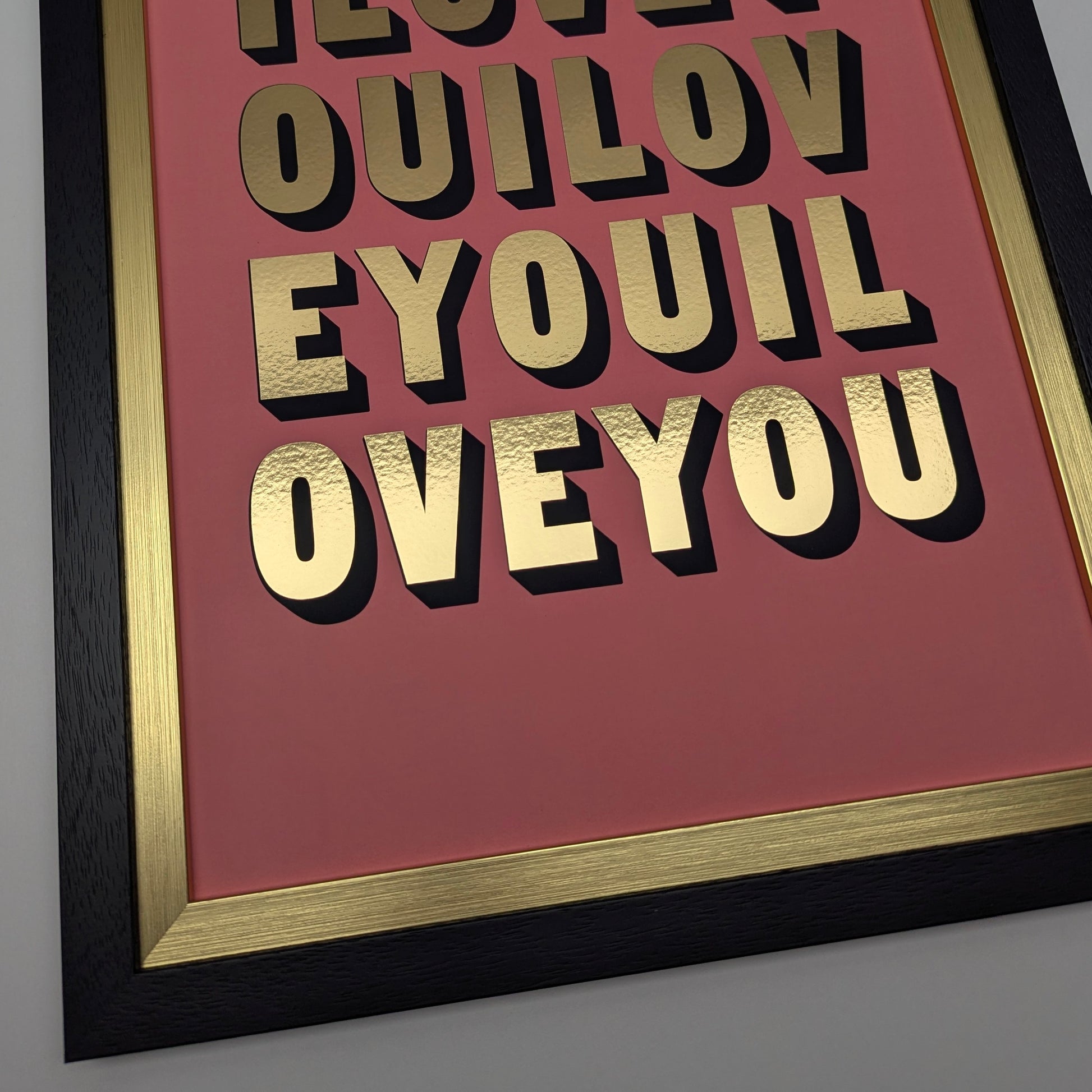 close up of framed artwork with 'I YOU LOVE' text on a pink background