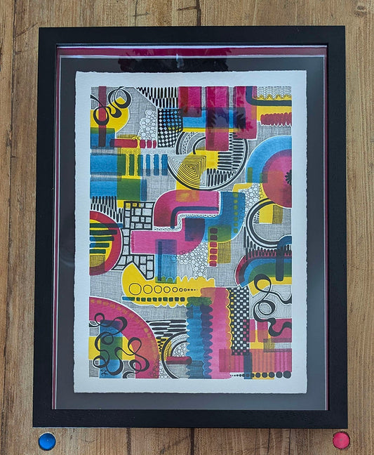 black frame against a wood background, colourful doodle shades of pink, blue, yellow and black. artwork by clare capper.