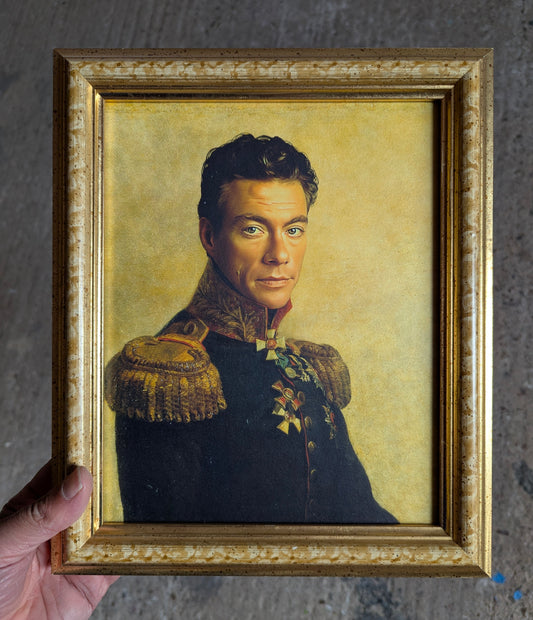 Framed portrait of a Jean-Claude van damme in military uniform against a textured gray background