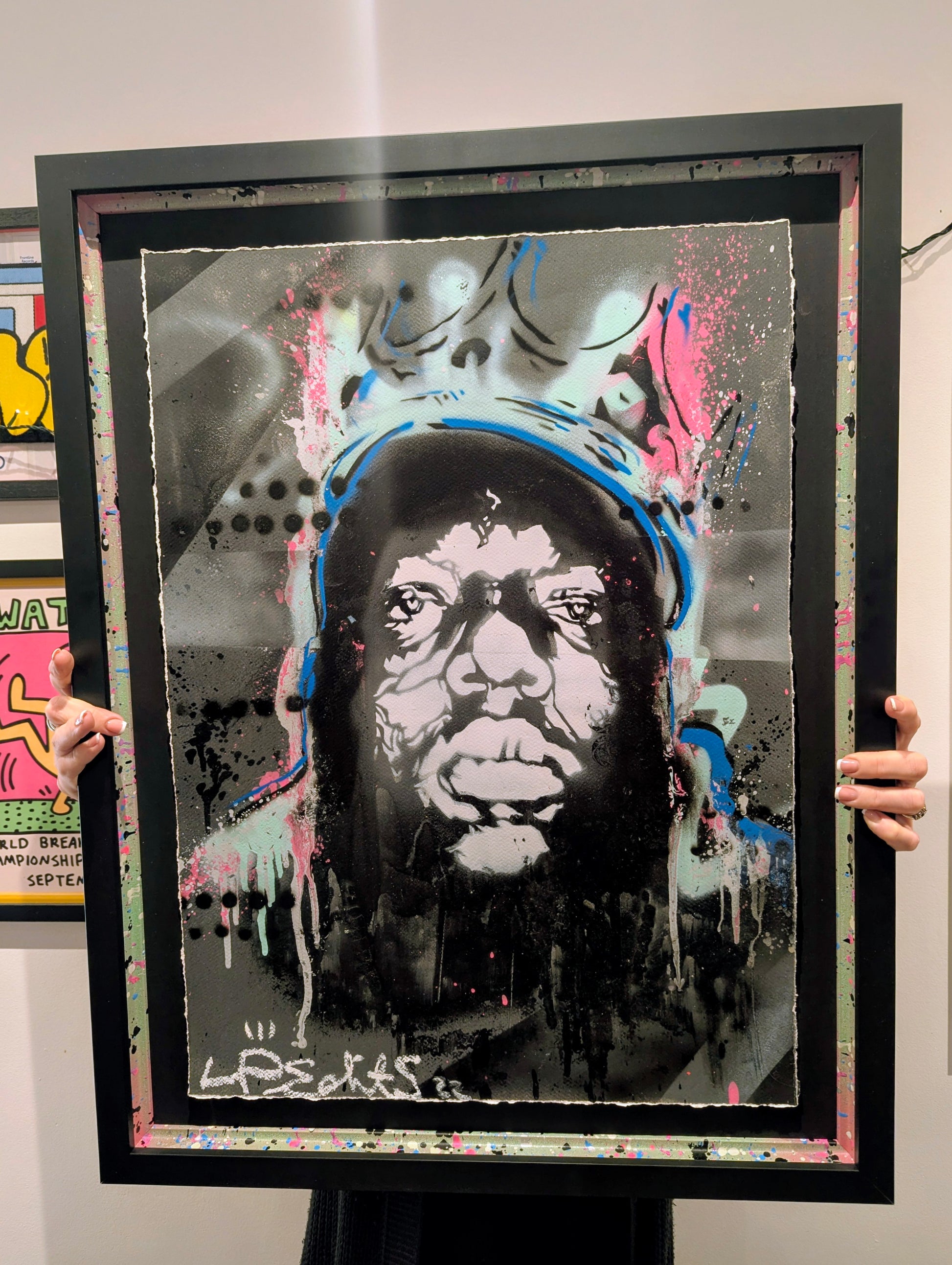 Framed artwork of a Biggie small wearing a crown with abstract designs.