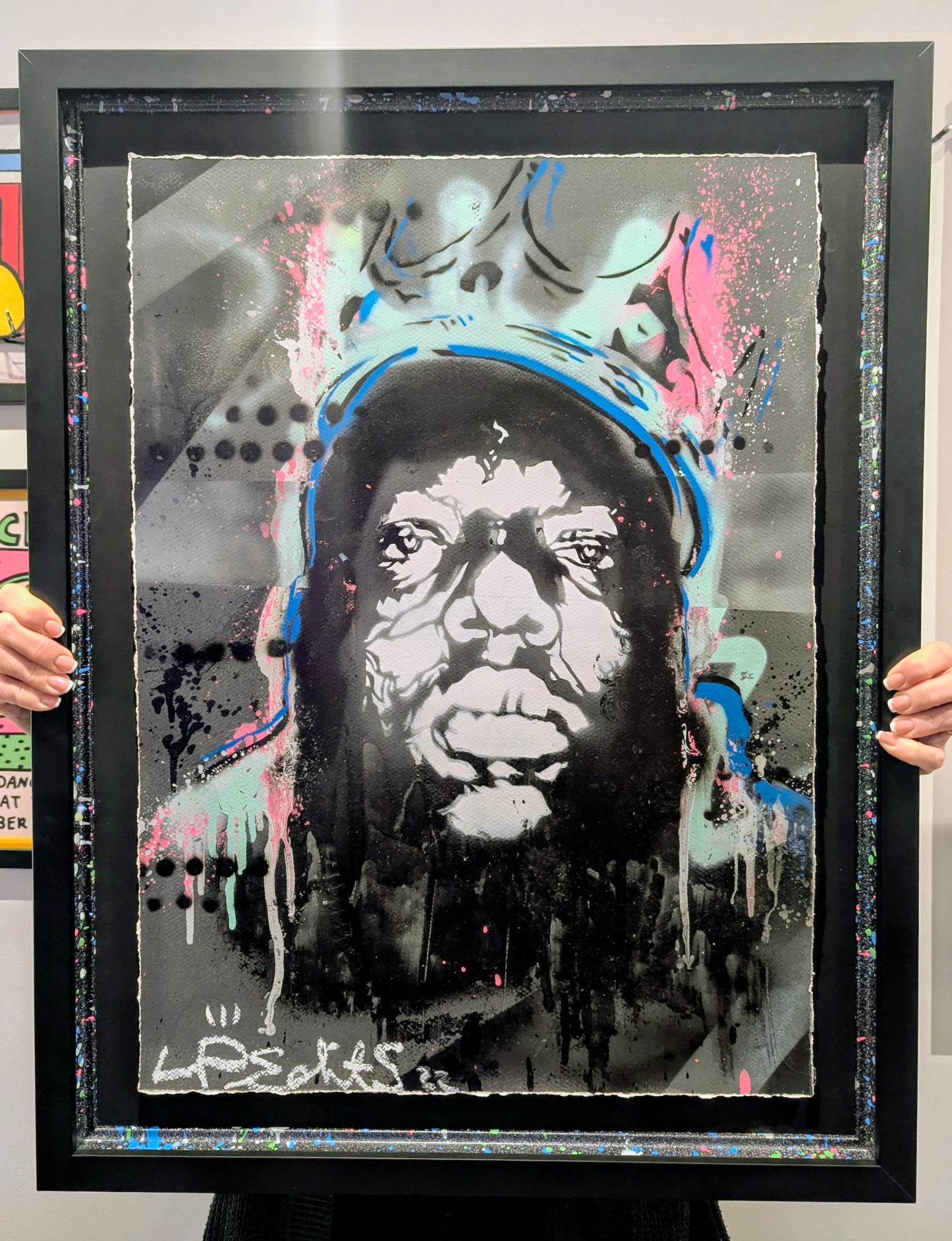 Framed artwork of a stylized portrait of Biggie smalls wearing a crown with abstract elements