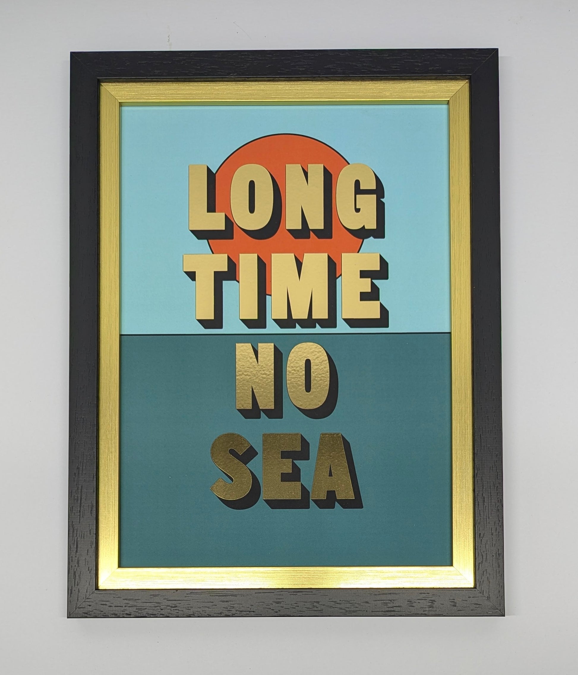 Gold writing long time no sea in black gold frame against a white background 