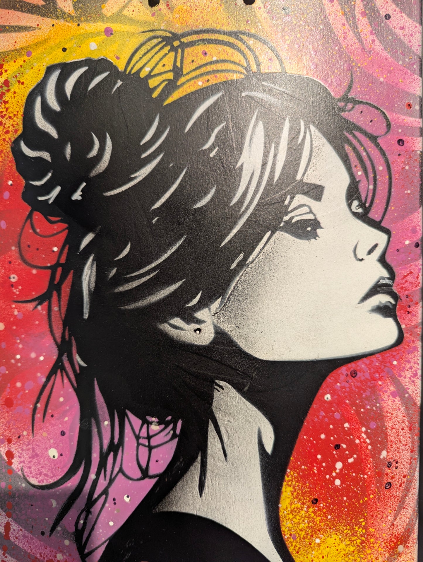 close up of woman's face on multi coloured background 