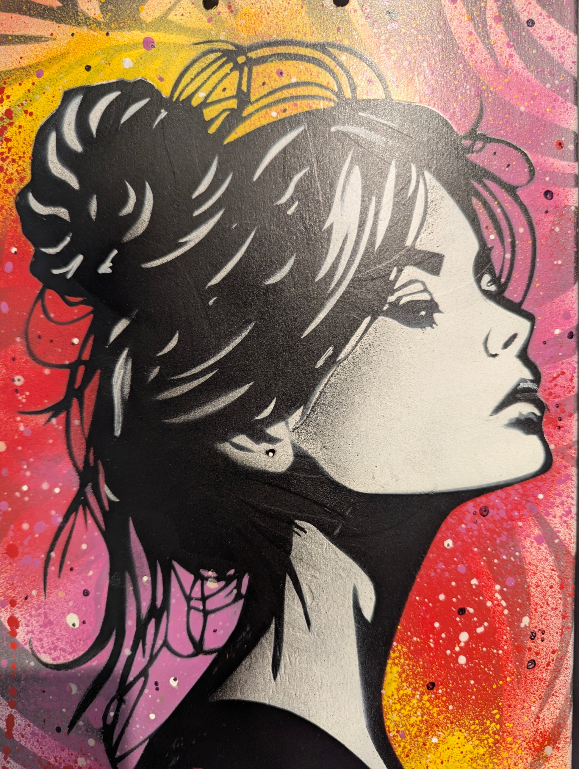 close up of woman's face on multi coloured background 