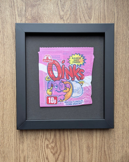 Framed Oinks snack packet on a wooden surface