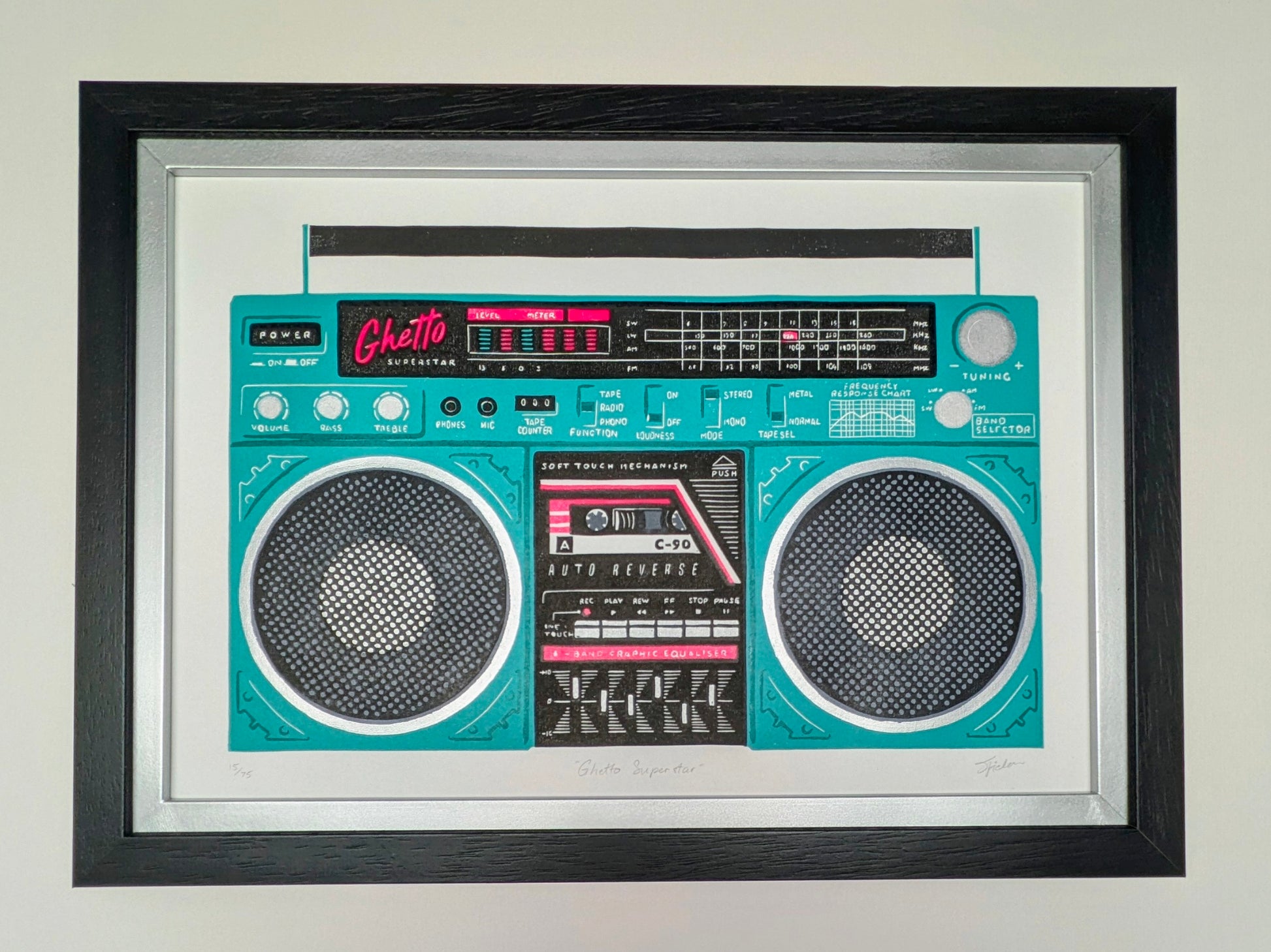 A framed art print depicting a retro boombox-style radio in bright turquoise and black, mounted on a light wall. The print is enclosed in a white mat and a thick black frame.