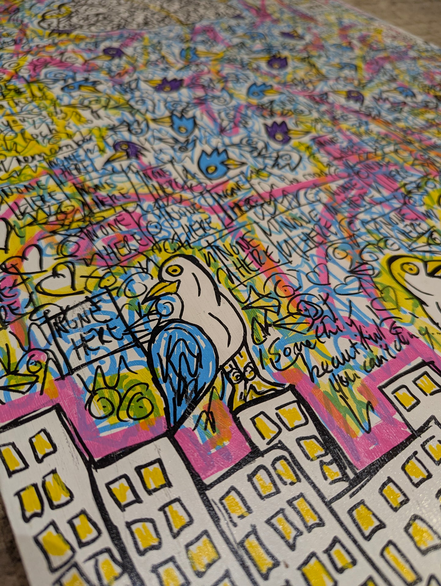 Colorful artwork with birds and text on a textured surface