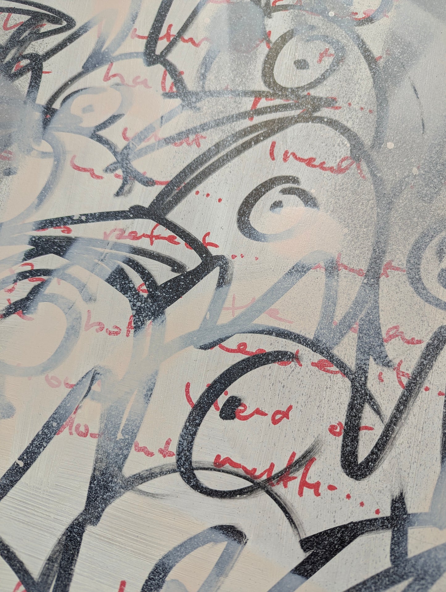 Black and red doodles of bird heads on washed white board 