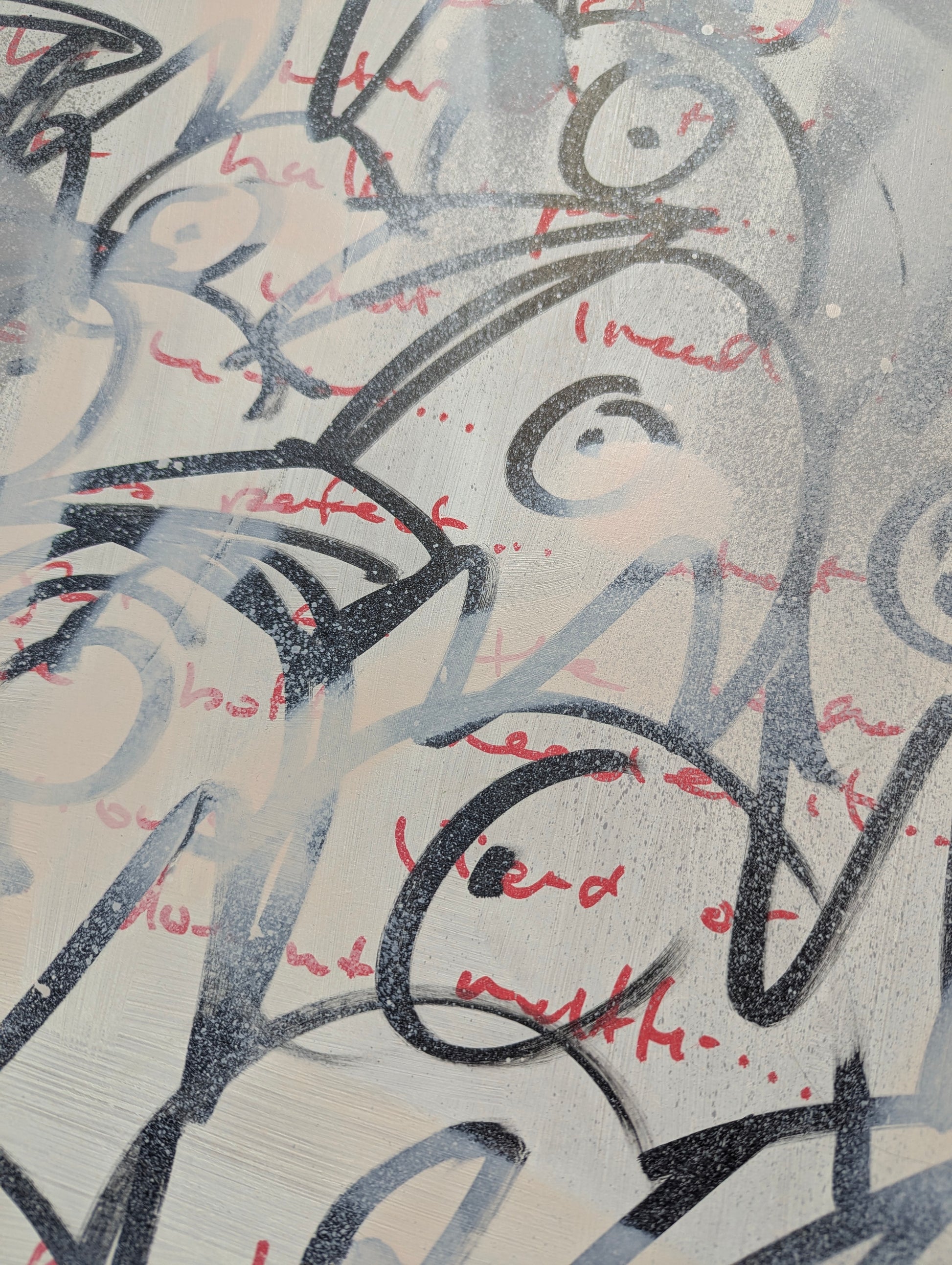 Black and red doodles of bird heads on washed white board 