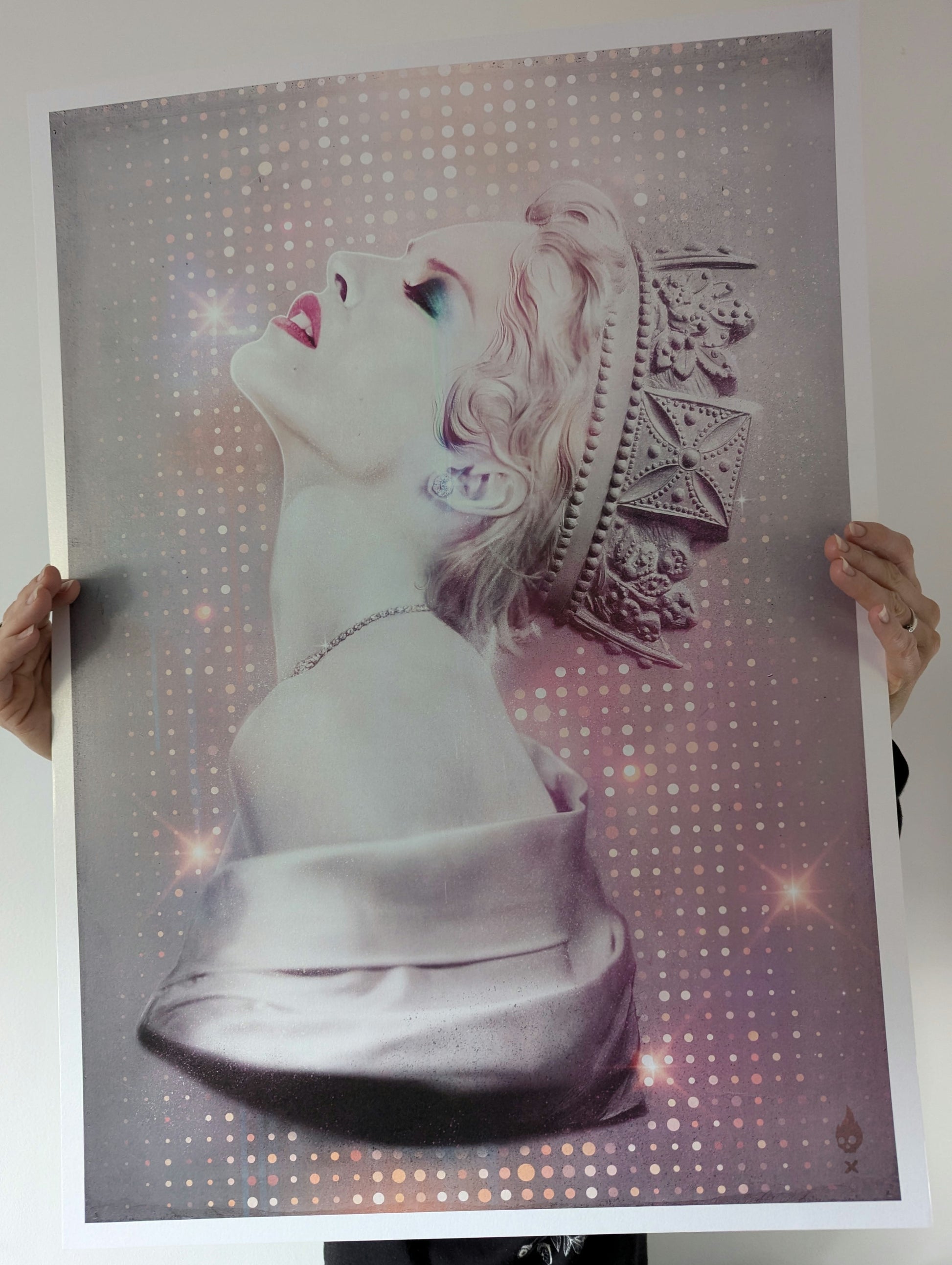 Tiny Riot Disco Queen Kylie Minogue, artwork is on paper background is pink and purple with glitter style spots surrounding and image of kylie Minogue upper body wearing a crown. artwork is being held in the air and you can see the hands.
