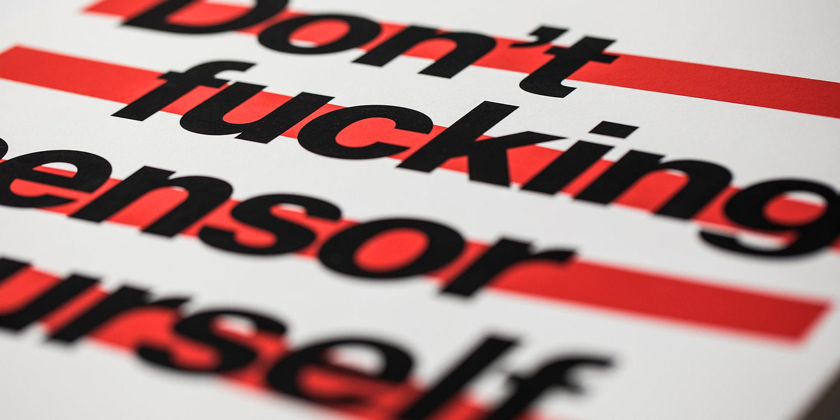 good fucking design advice don't censor yourself, close up of text. artwork is on white paper, text is black with red lines behind it