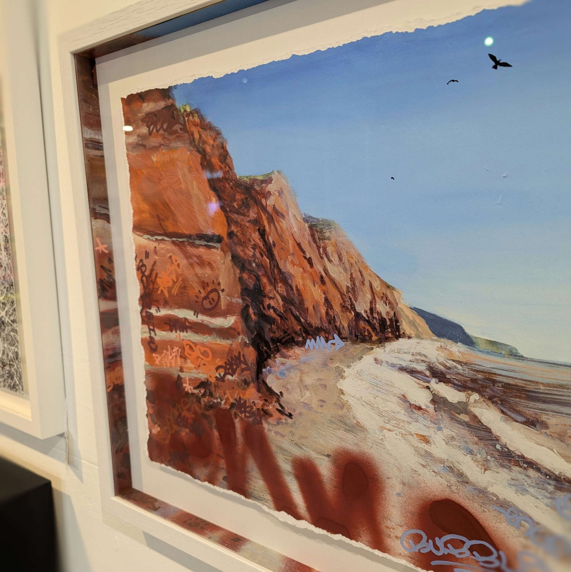 close up of the red cliffs and matching slips for joe webster artwork, the cliffs also have graffiti colour matching the cliffs
