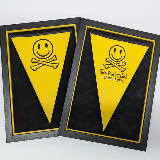 two black and yellow picture frames both have yellow bunting float mounted, smiley face and cross bones 