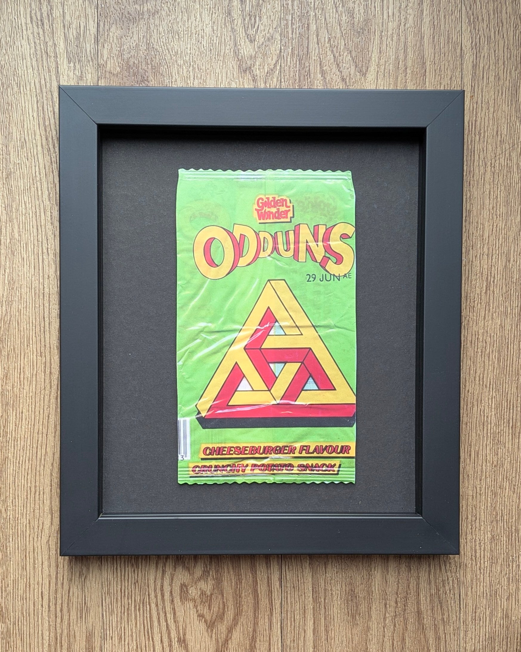 Framed Odduns snack packet on a wooden surface