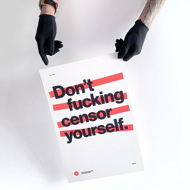 good fucking design advice don't censor yourself being held by person wearing black gloves. artwork is on white paper, text is black with red lines behind it