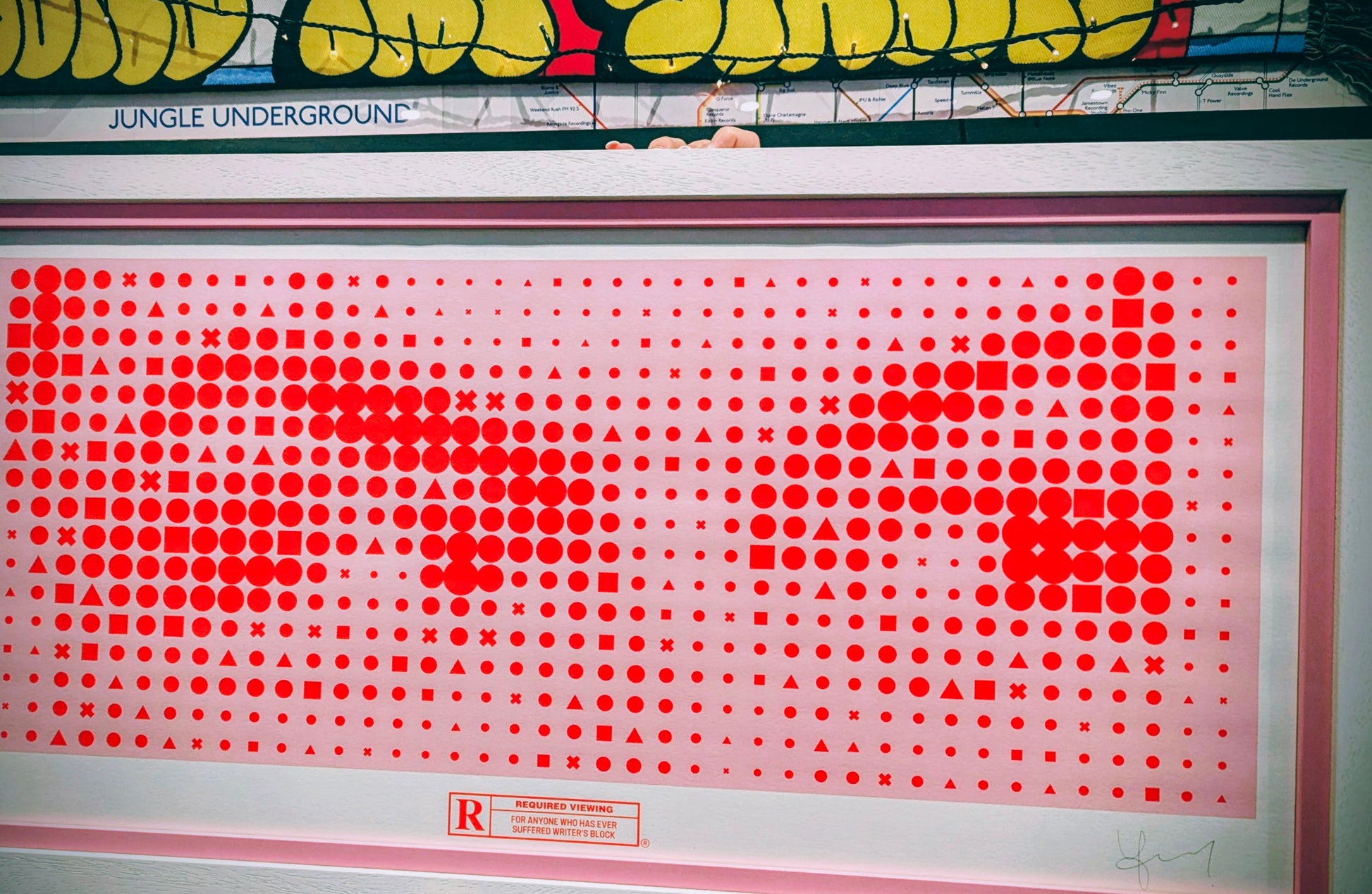 Framed artwork with red dot pattern of the eyes from the shining, frame is pink with outer white frame