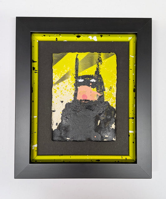 Framed abstract batman in bespoke frame, person holding it in front of other frames
