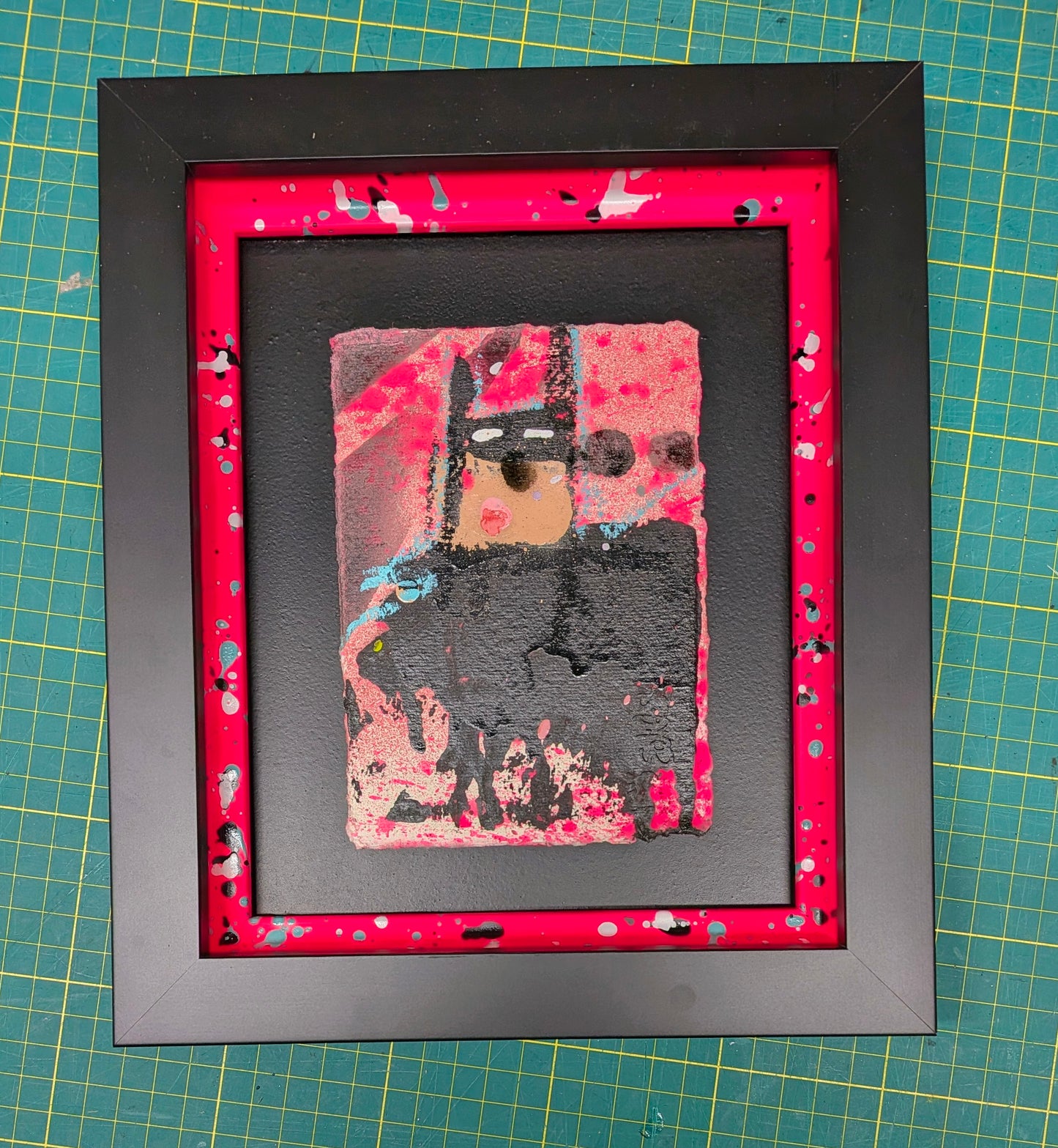 Framed abstract artwork of batman with a red border on a grid background