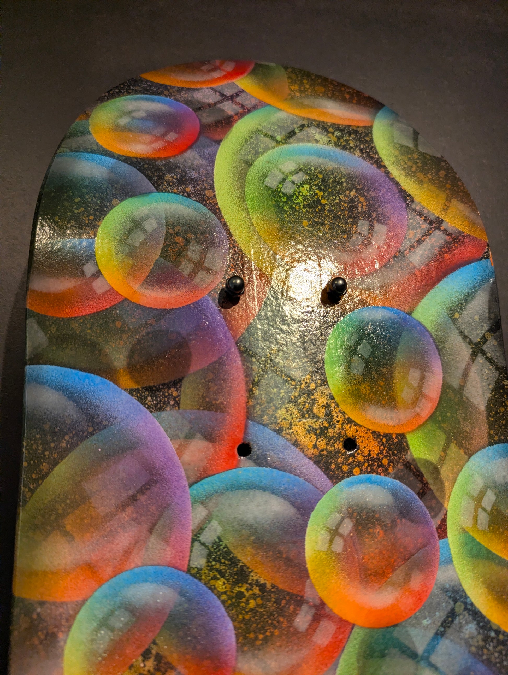 Colorful bubble-like shapes on a textured surface