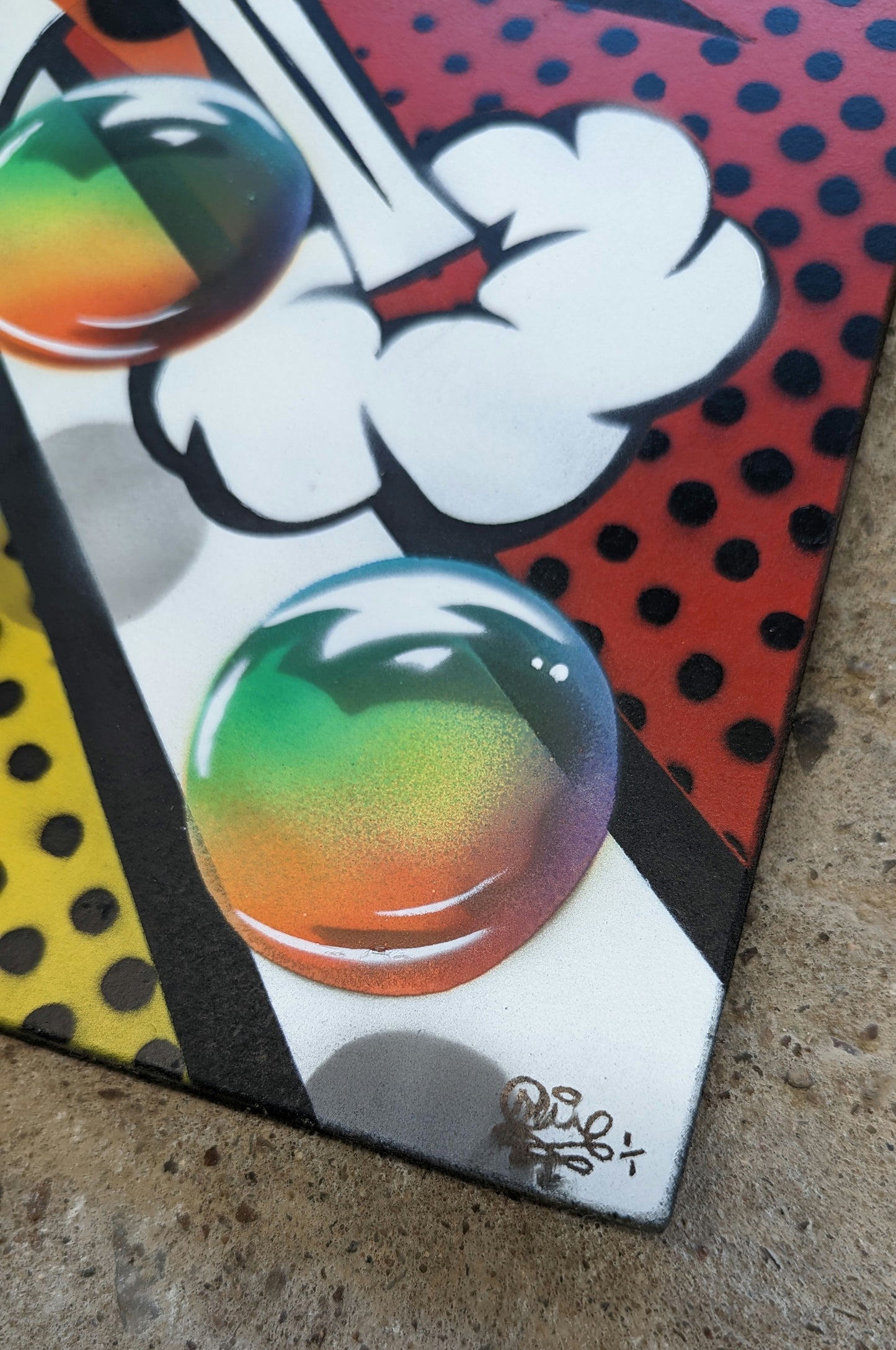 colorful bubble against a polka dot background, artwork against concrete background