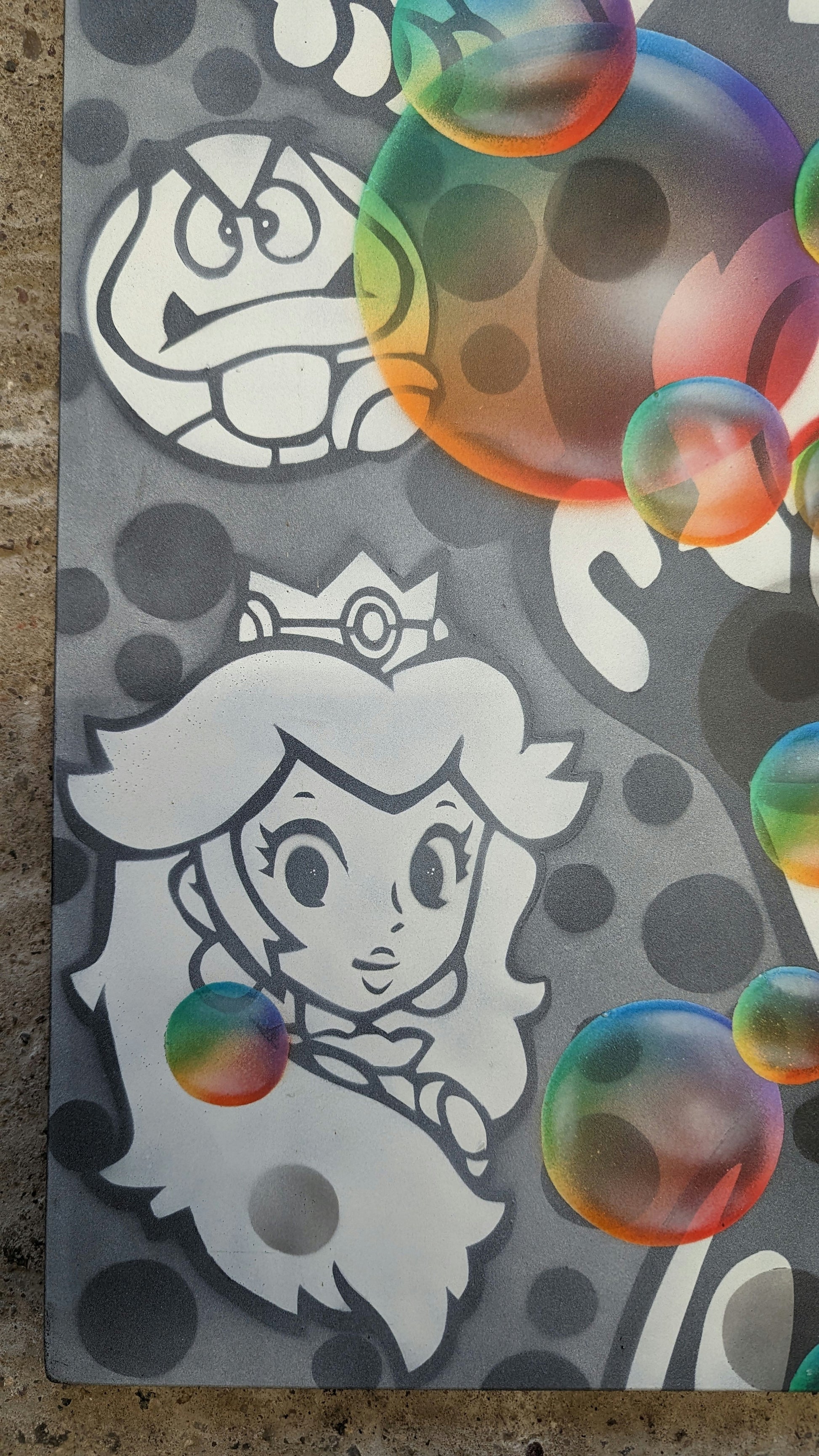 close up of nme super mario character princess peachon concrete background