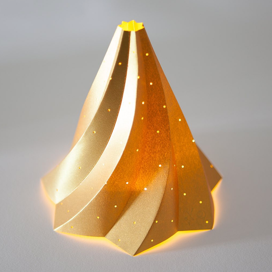 gold colour Decorative Christmas tree paper sculpture  with a star at the top on a grey background
