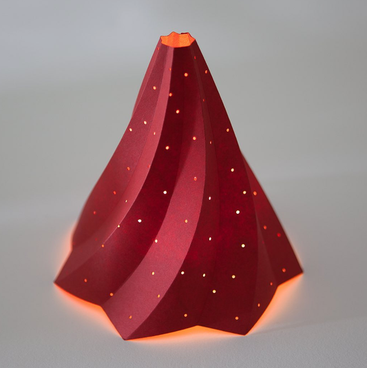 red Decorative Christmas tree paper sculpture  with a star at the top on a grey background