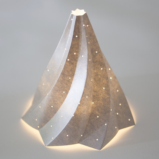 tree paper sculpture  with a star at the top on a grey background