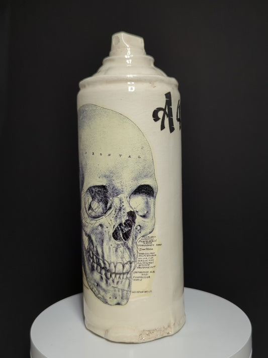 video of ceramic spray rotating on base, can is by Adam Graddon, spraycan is cream ceramic with blue skull